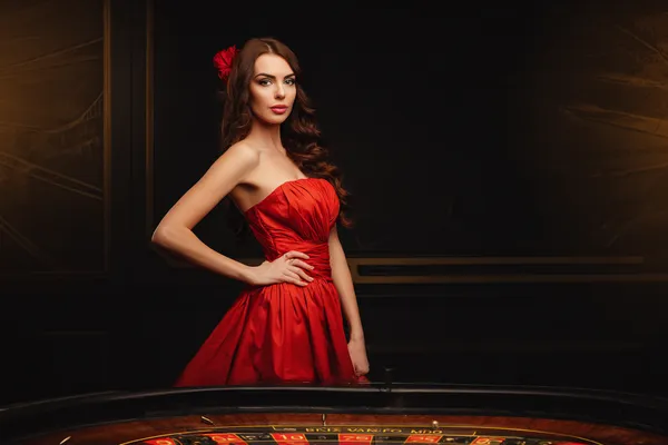 A young woman relaxing with her phone while dynamic casino elements float around her, illustrating the smooth mobile experience offered by the BD111 app.
